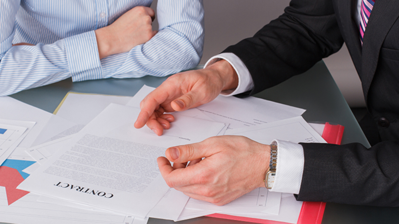 Businessman and business woman at business meeting. Business people discussing business papers.